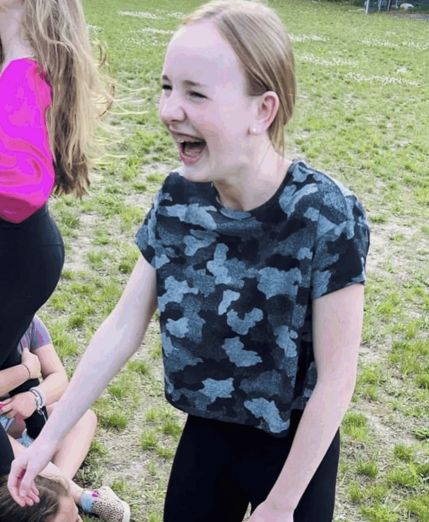 Teen girl laughing and having fun during the summer camp for girls. 